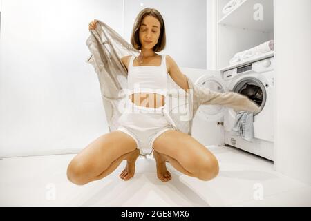 Woman wearing fresh clothes in bathroom Stock Photo