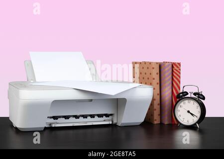 Compact home laser printer against pink background Stock Photo