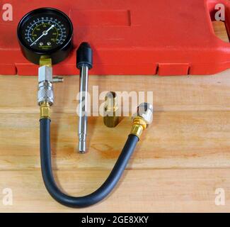 Closeup of a compression tester on the wooden table Stock Photo