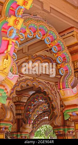 Detail from the brightly decorated Burmese teak archways in the Hindu Shri Swaminarayan Temple in Ahmedabad, India Stock Photo