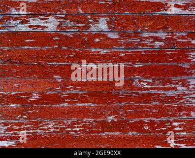 Color-Peel wood texture. Old wooden painted light red rustic fence, paint peeling background Stock Photo