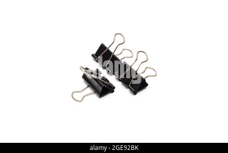 Black metal binder paper clips on an isolated white background Stock Photo