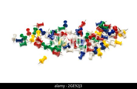 A lot of scattered paper push pins on an isolated white background Stock Photo
