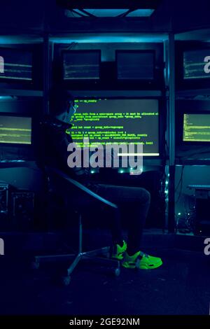 Cyber hacker breaks into databases to obtain information using a computer. Cybercrime and data security concept. Stock Photo