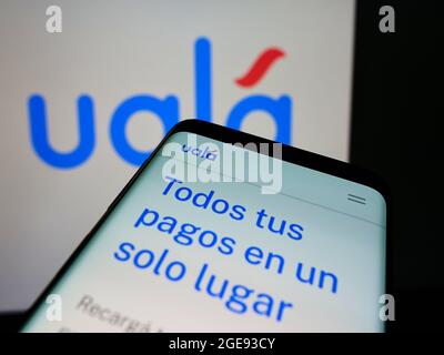 Smartphone with logo of Argentine fintech Alau Tecnología S.A.U. (Ualá ...