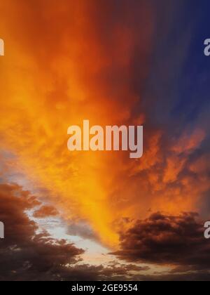 Colorful autumn sunset sky. Vertical background, abstract clouds shapes and colors. October seasonal celestial beauty. Panoramic dusk cloudscape scene Stock Photo