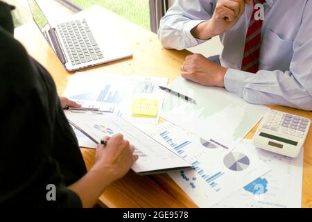 The businessperson is listening to the input from the team to make decisions on the company's marketing planning programs. Stock Photo