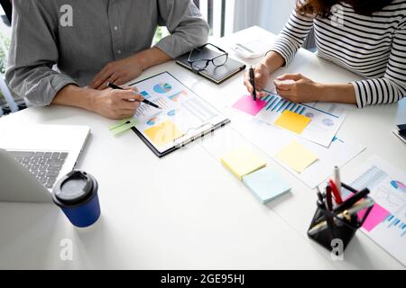 Young business woman  are explaining business plans to staff team for startup business with graph and chart in marketing plan meeting. Stock Photo