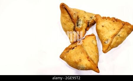 Potato samosa on white background, Traditional indian or pakistani ramadan food, Spicy street food, Famous snacks in asian country. Stock Photo