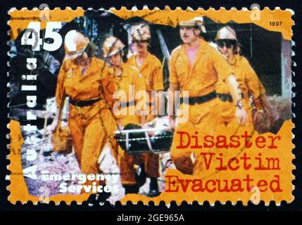 AUSTRALIA - CIRCA 1997: a stamp printed in the Australia shows Disaster Victim Evacuated, circa 1997 Stock Photo