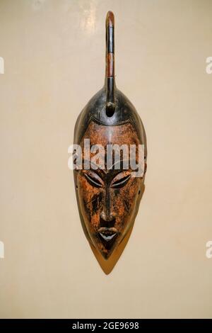 Parma, Italy: African mask on white wall close-up in the museum of Magnani Rocca Stock Photo