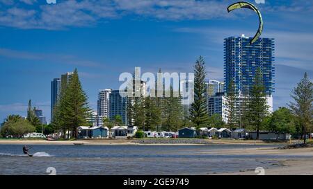 Surfers Paradise, Queensland Australia - February 23, 2021: Man Kite Surfing in Front of Gold Coast High Rise Stock Photo
