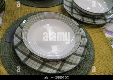 checkered plates and cutlery on table. still life table setting. tablecloth, beautiful plates. Table Stock Photo