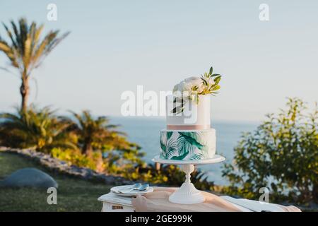 Wedding cake on table near sea Stock Photo