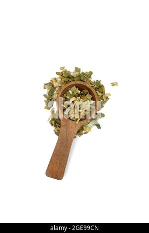 Dry chopped leeks in a wooden spoon isolated on white background. Stock Photo