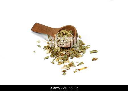 Dry chopped leeks in a wooden spoon isolated on white background. Stock Photo