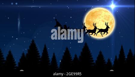 Composition of santa claus in sleigh with reindeer over stars and moon Stock Photo