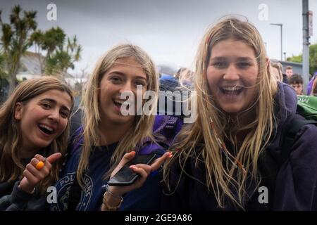 A group of excited young girls arriving at Newquay Train Station for the Boardmasters Festival in Cornwall. Stock Photo