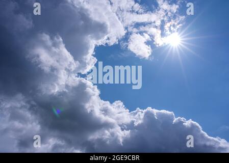 Light shining throug dark clouds. Stock Photo