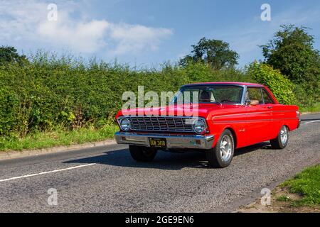 1964 60s sixties red American Ford Falcon Sprint 4230cc petrol pony car en-route to Capesthorne Hall classic July car show, Cheshire, UK Stock Photo