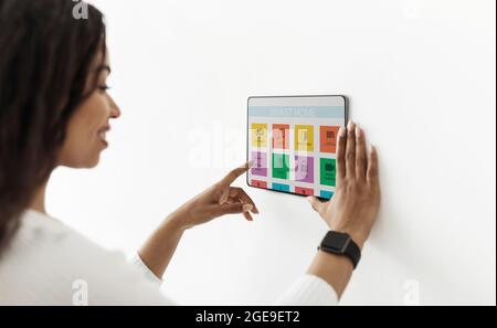 Black housewife enjoying her smart home automatic system Stock Photo