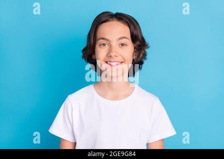 Photo portrait schoolboy smiling in white t-shirt isolated pastel blue color background Stock Photo