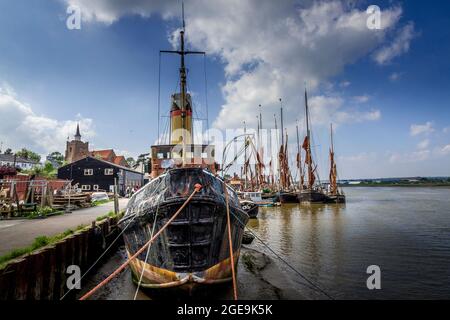 The steam tug Brent and several Thames Sailing Barges at Maldon quayside. Stock Photo