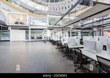 Interior of empty coworking space with covered computers Stock Photo