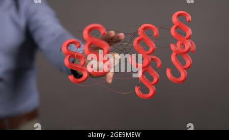 3D render of floating paragraph law and justice symbols near a lawyer's hand Stock Photo