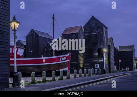 An old fishing boat and the Net Shops in Hastings old town. Stock Photo