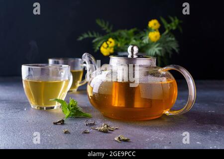 Green tea in a clear glass teapot  Stock Photo