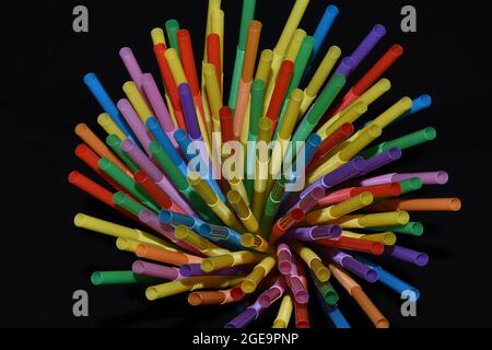 Plastic straws isolated on a black background. Stock Photo