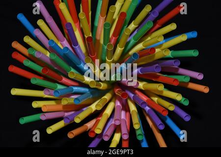 Multicolored straws isolated on black background. Stock Photo