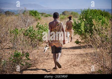 hunting bushmen of Hadzabe  tribe with bow and arrow, Lake Eyasi, Tanzania, Africa Stock Photo