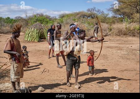 bushmen of Hadzabe  tribe train the hunt with bow and arrow, Lake Eyasi, Tanzania, Africa Stock Photo