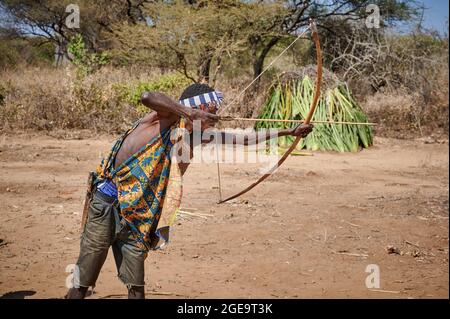 bushmen of Hadzabe  tribe train the hunt with bow and arrow, Lake Eyasi, Tanzania, Africa Stock Photo