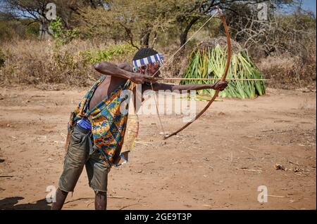 bushmen of Hadzabe  tribe train the hunt with bow and arrow, Lake Eyasi, Tanzania, Africa Stock Photo