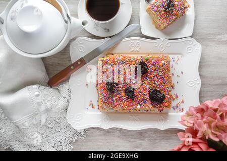 Top view delicious traditional Turron de Dona Pepa dessert with colorful dragee served on plate on table Stock Photo