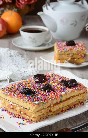 Delicious traditional Turron de Dona Pepa dessert with colorful dragee served on plate on table Stock Photo