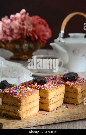 Delicious traditional Turron de Dona Pepa dessert with colorful dragee served on plate on table Stock Photo