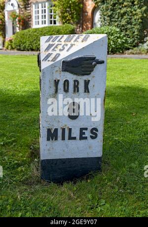 Close up of old black and white painted road sign to York. Stock Photo