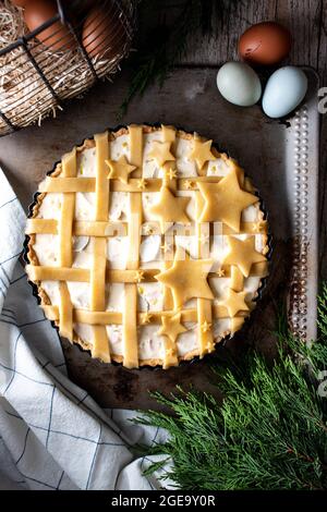 From above delicious stars quiche pie ready to bake with eggs decorated stars from dough in baking dish Stock Photo