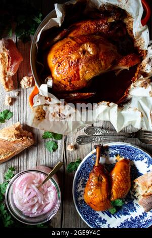 From above beautiful thanksgiving dinner with roasted chicken Pollo pibil on wooden table Stock Photo