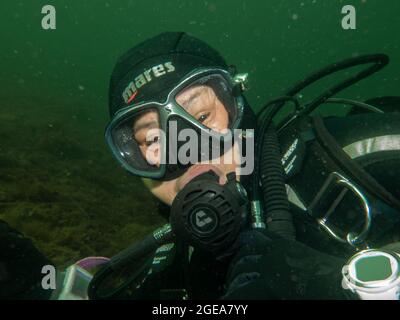 August 4, 2021 - Malmo, Sweden: A close-up picture of a female scuba diver. Many have been introduced to cold water diving after travel restrictions have taken place Stock Photo