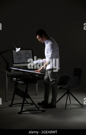 Chinese designer working on construction plan Stock Photo
