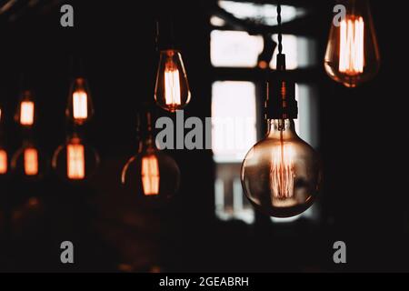 beautiful decorative light bulbs hang on the cords. beautiful lighting fixtures. High quality photo Stock Photo