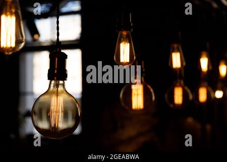 beautiful decorative light bulbs hang on the cords. beautiful lighting fixtures. High quality photo Stock Photo