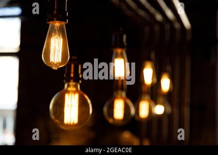 beautiful decorative light bulbs hang on the cords. beautiful lighting fixtures. High quality photo Stock Photo