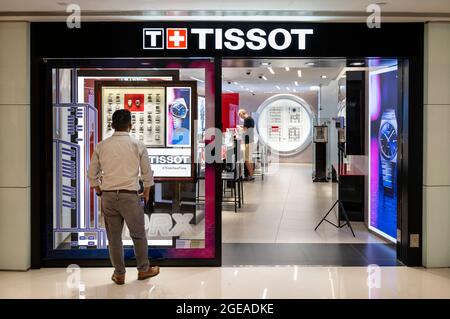 A shopper is seen at the Swiss watchmaker Tissot store in Hong