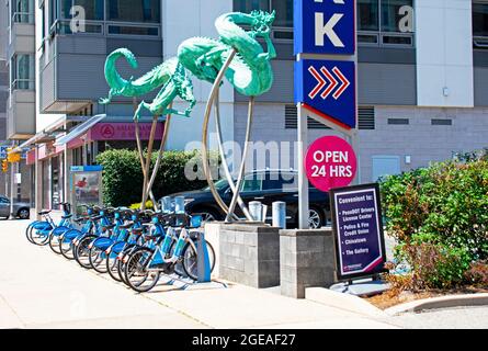 Green flying dragons guard a row of rental bicycles adjacent to a parking lot in Philadelphia's Chinatown Stock Photo